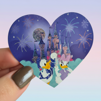 Heart-shaped Disney-themed sticker with castle and characters against a blue and white checkered background.