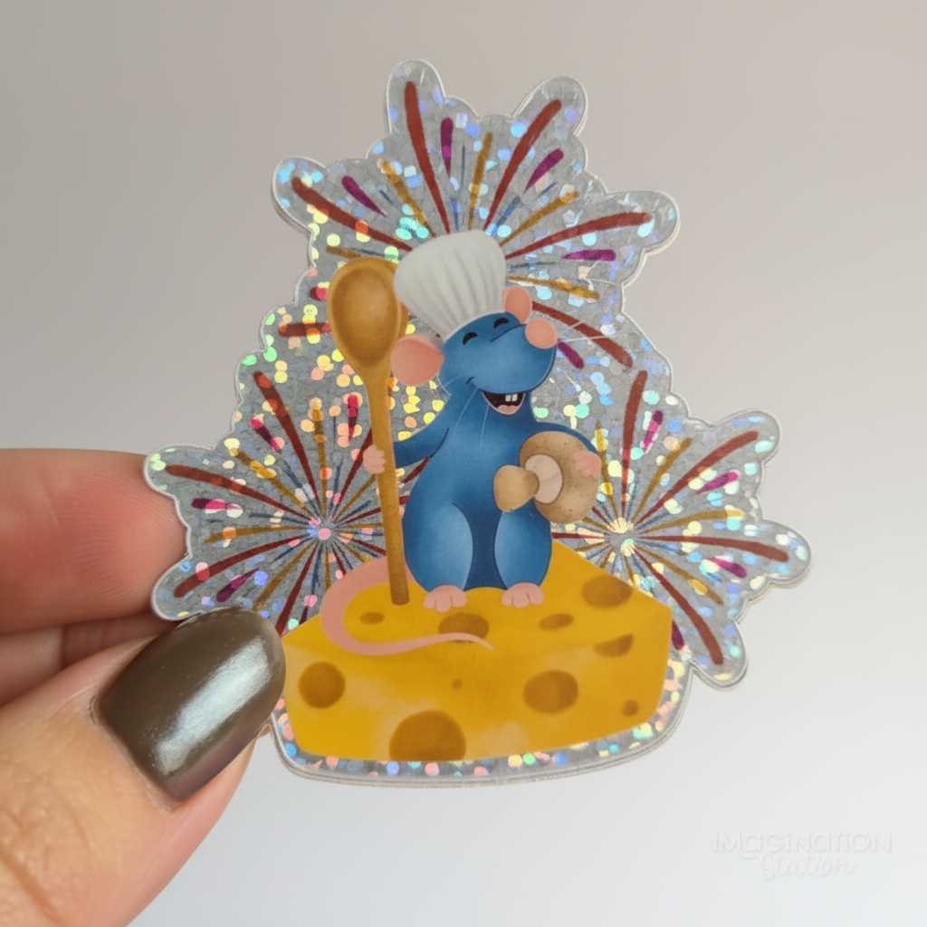 Holographic sticker of a cartoon mouse holding a wooden spoon on a cheese block with fireworks in the background.