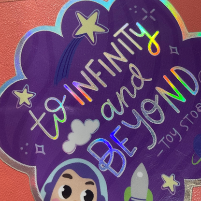 Holographic 'To Infinity and Beyond' sticker with cartoon character on a purple background